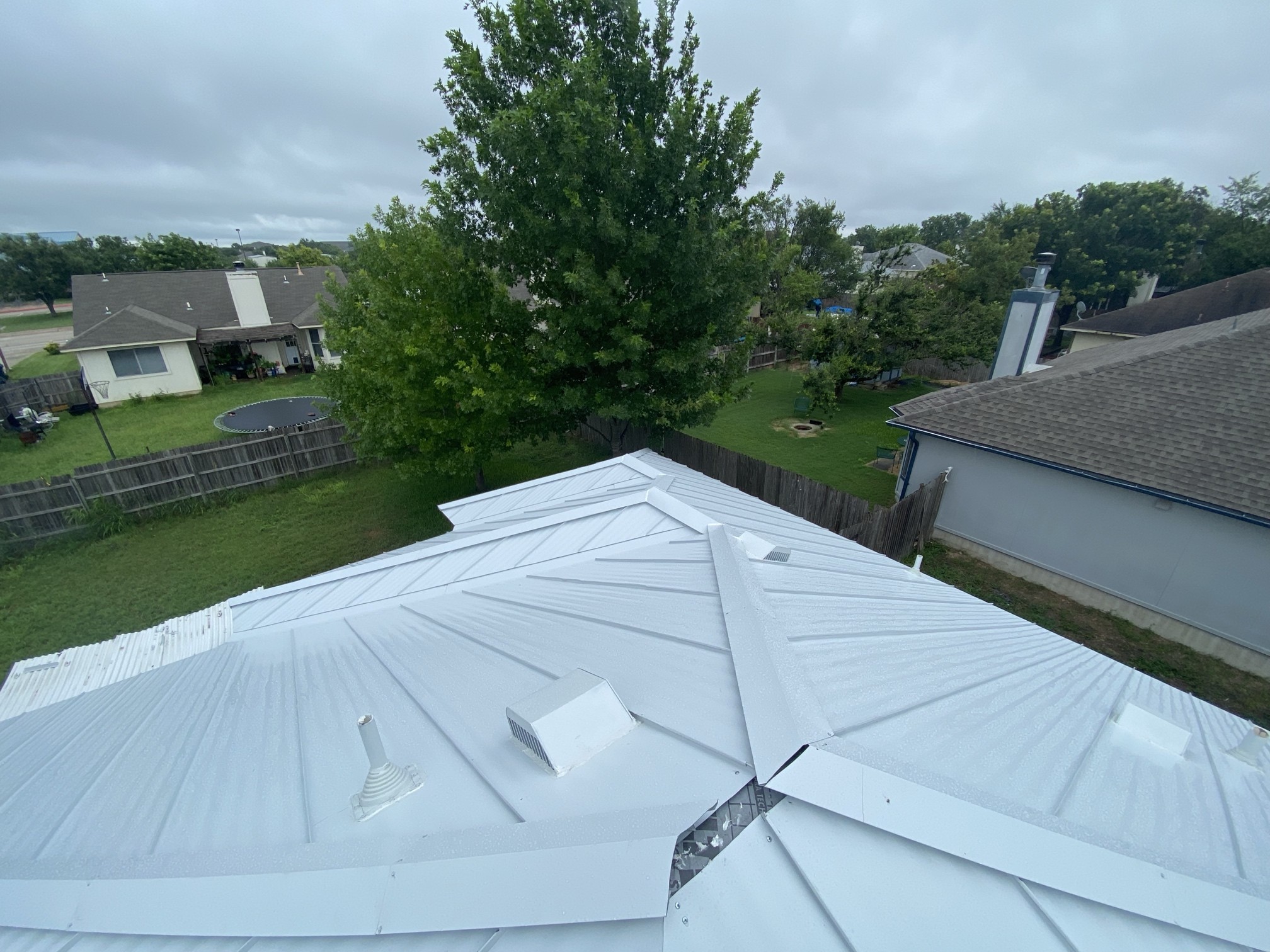 Metal roof with hips, intersecting slopes and trim. Roof geometry affects the scope of a metal-roof estimate.