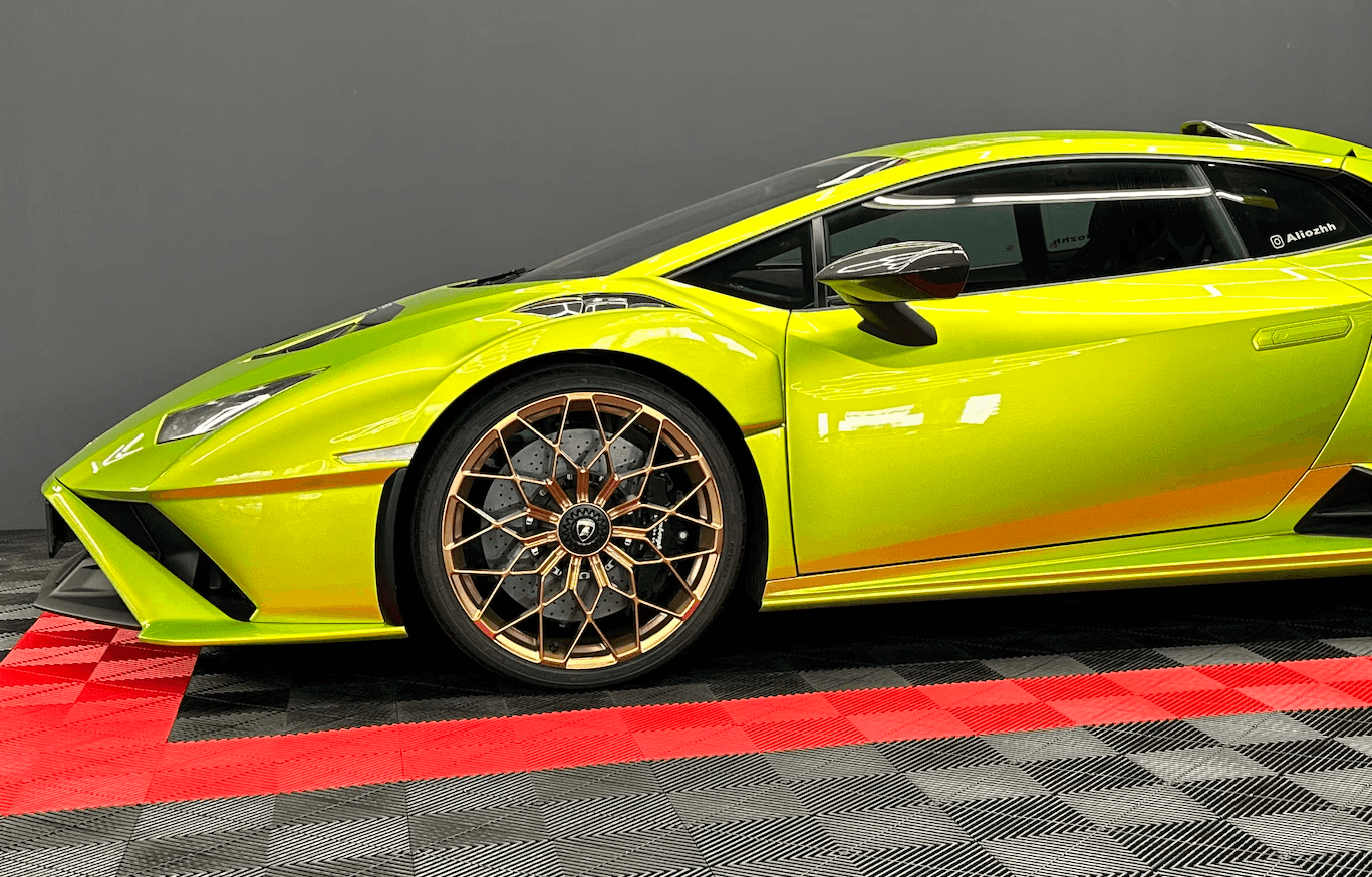 A car parked in a field at sunset