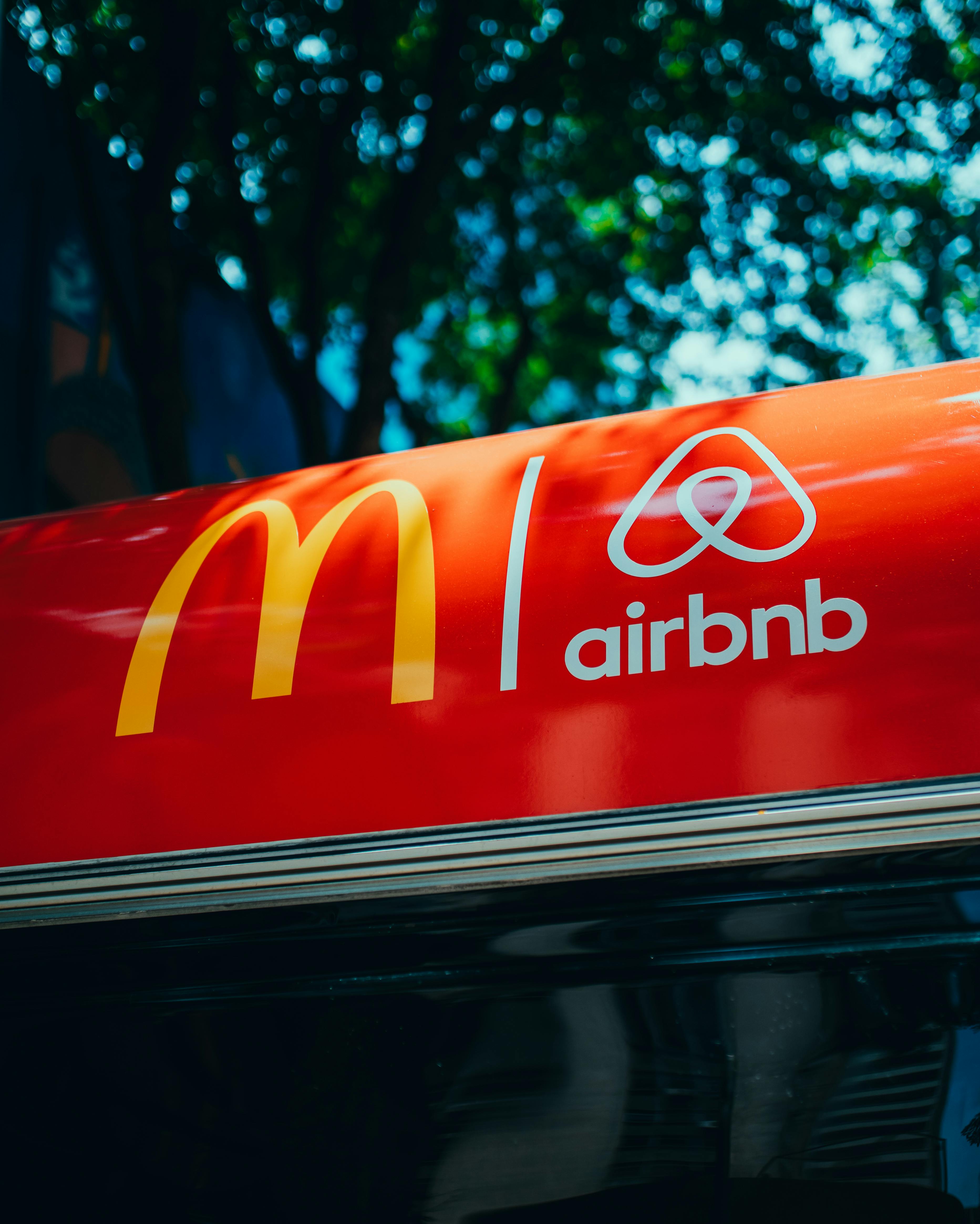 a-vibrant-red-sign-featuring-logos-of-mcdonald's-and-airbnb-in-an-urban-setting. - matheus-bertelli (pexels)