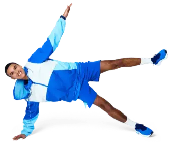 A person in a blue athletic outfit is lying on the ground, stretching out one arm and leg.