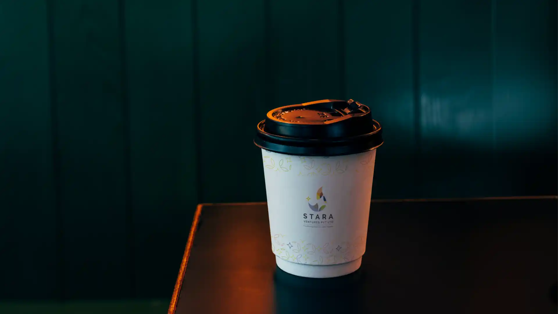 Stara Ventures branded takeaway coffee cup with custom pattern detail