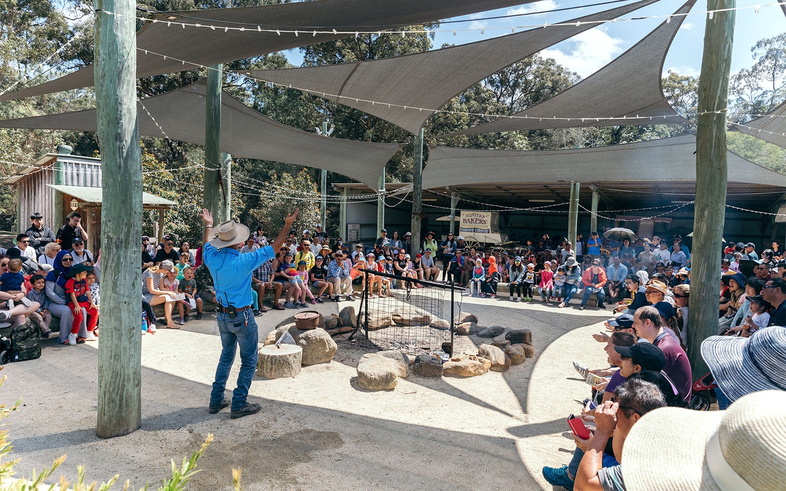 Audience watching a live show at Paradise Country with a performer in front.