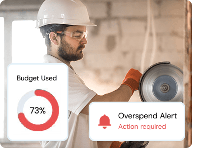 Worker in safety gear checking a site dashboard showing “Budget Used 73%” and “Overspend Alert,” symbolising proactive budget protection.