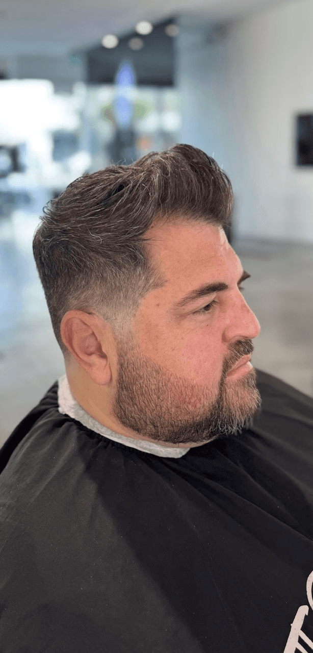 Salt-and-pepper grooming with tailored beard trim and professional fade haircut by Courtney Palmore in West Hollywood.