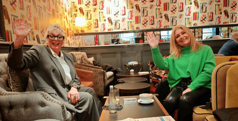 A beautiful young woman smiling at the camera on a mountain field