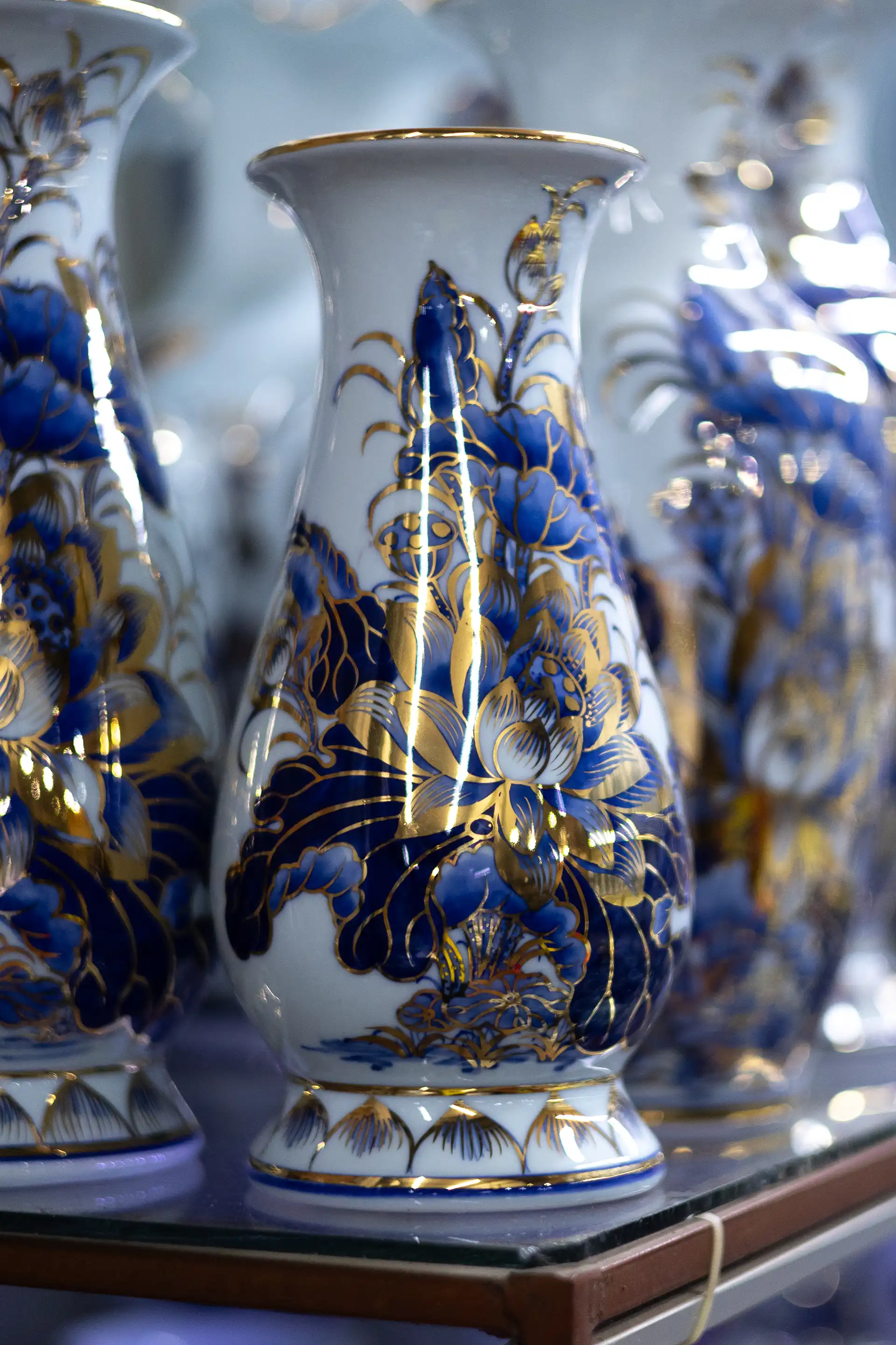 Close up of a white ceramics vase with a blue painting on it