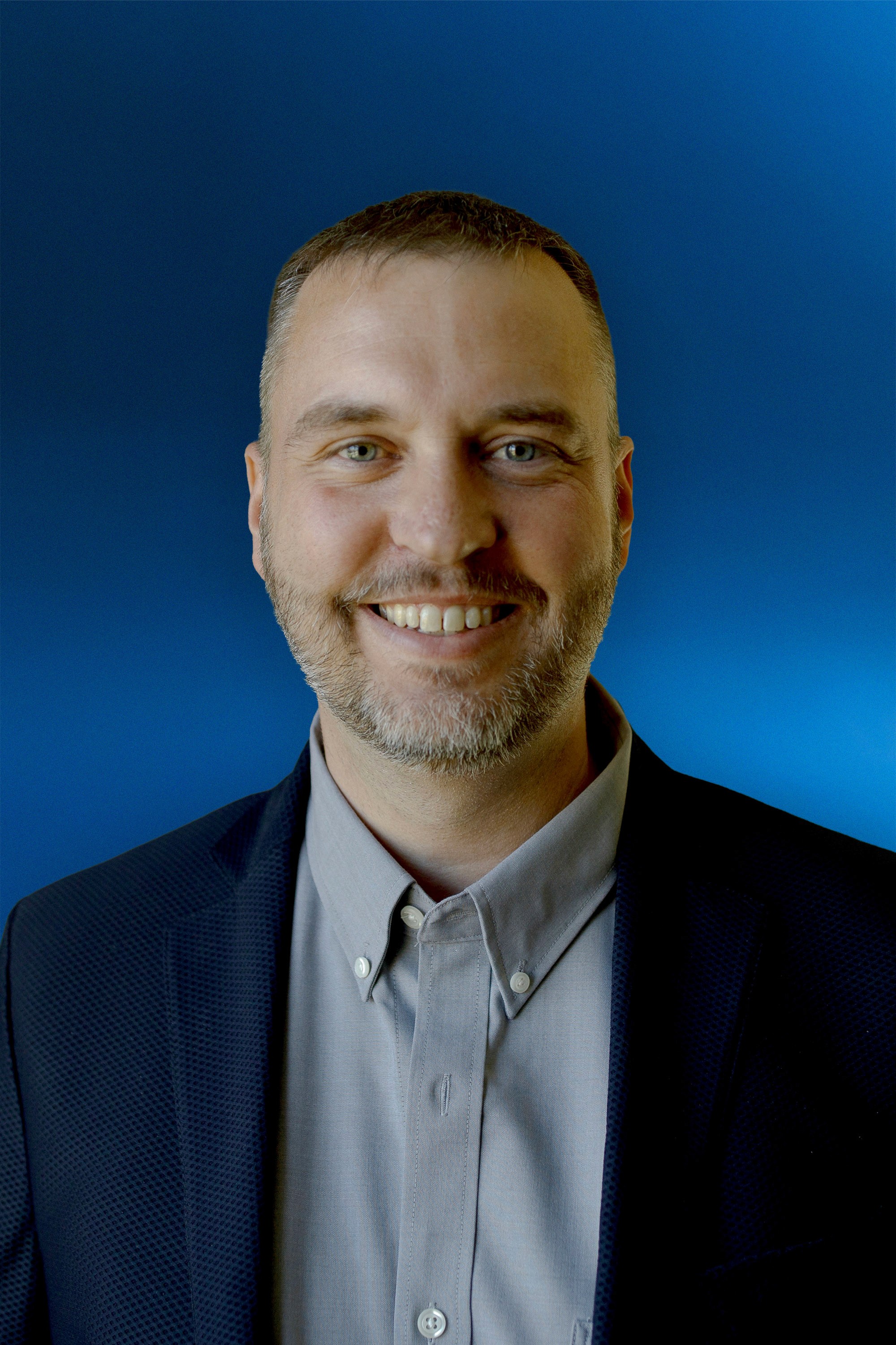 Portrait of a person in a pink sweater against a light background