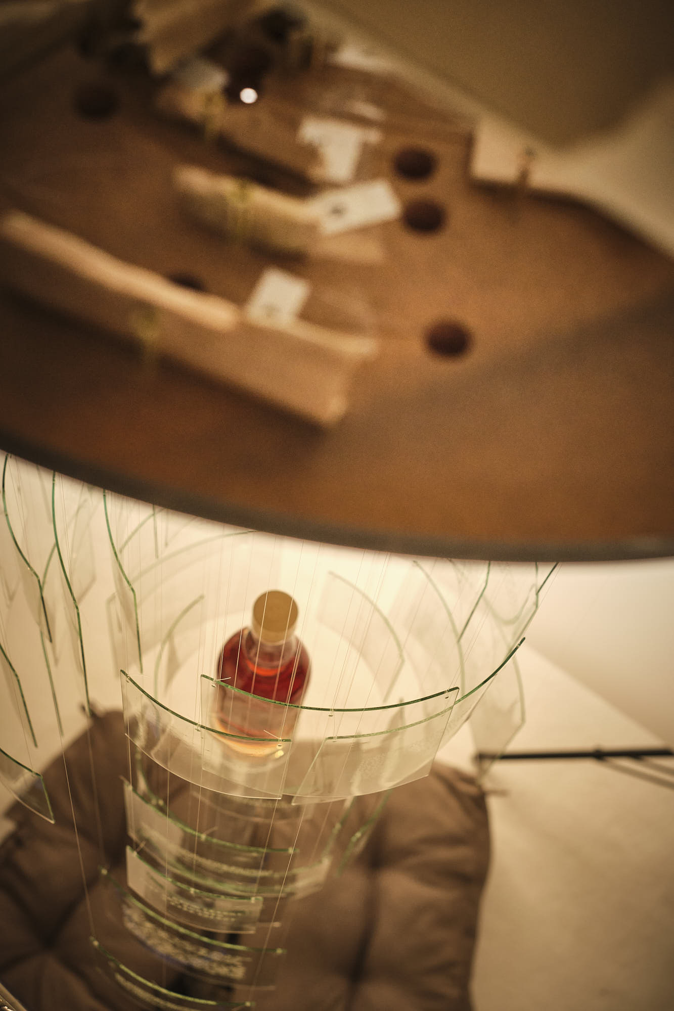 an abstract closeup of bottle staged in a glass panel