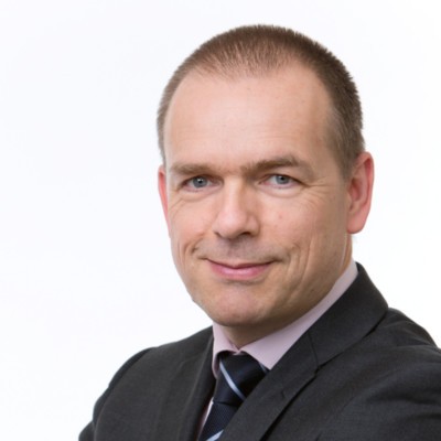 Young man in glasses wearing a black shirt indoors