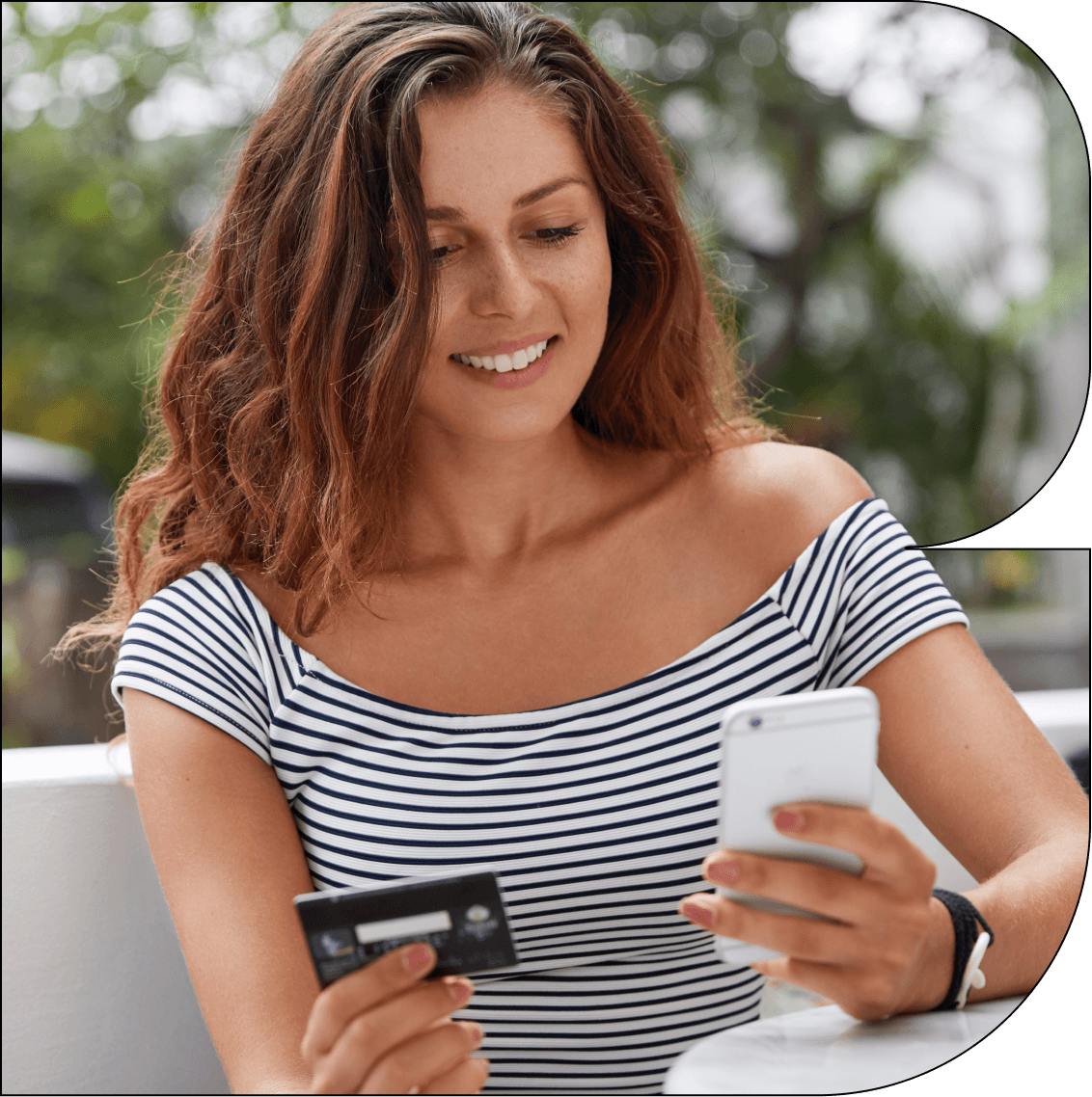 A young woman with long brown hair is sitting outside in a relaxed setting, holding a credit card in one hand and a smartphone in the other. She is smiling while making a purchase. A green icon displaying "Installments 3/4" overlays the image, indicating that she is using Breezy’s installment payment option.