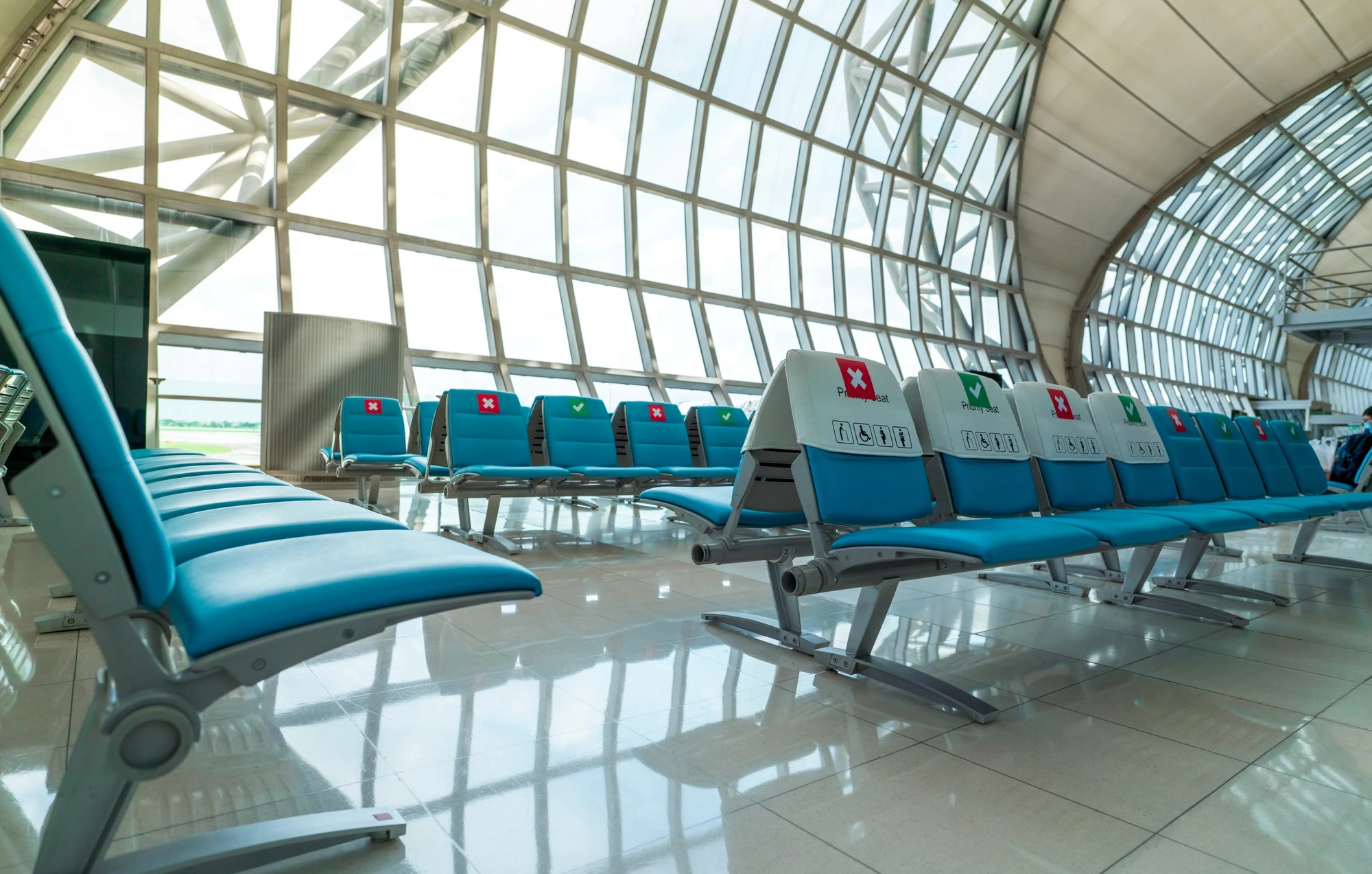 Airport rental car center seating installation with American flag and service counters.