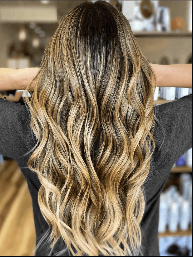 Lived-in blonde color melt with weft extensions by Tannya Speir at Del Sol Hair Studio Huntington Beach
