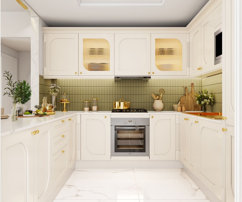 A white kitchen featuring gold accents and elegant marble flooring at Vincitore Wellness Estate.