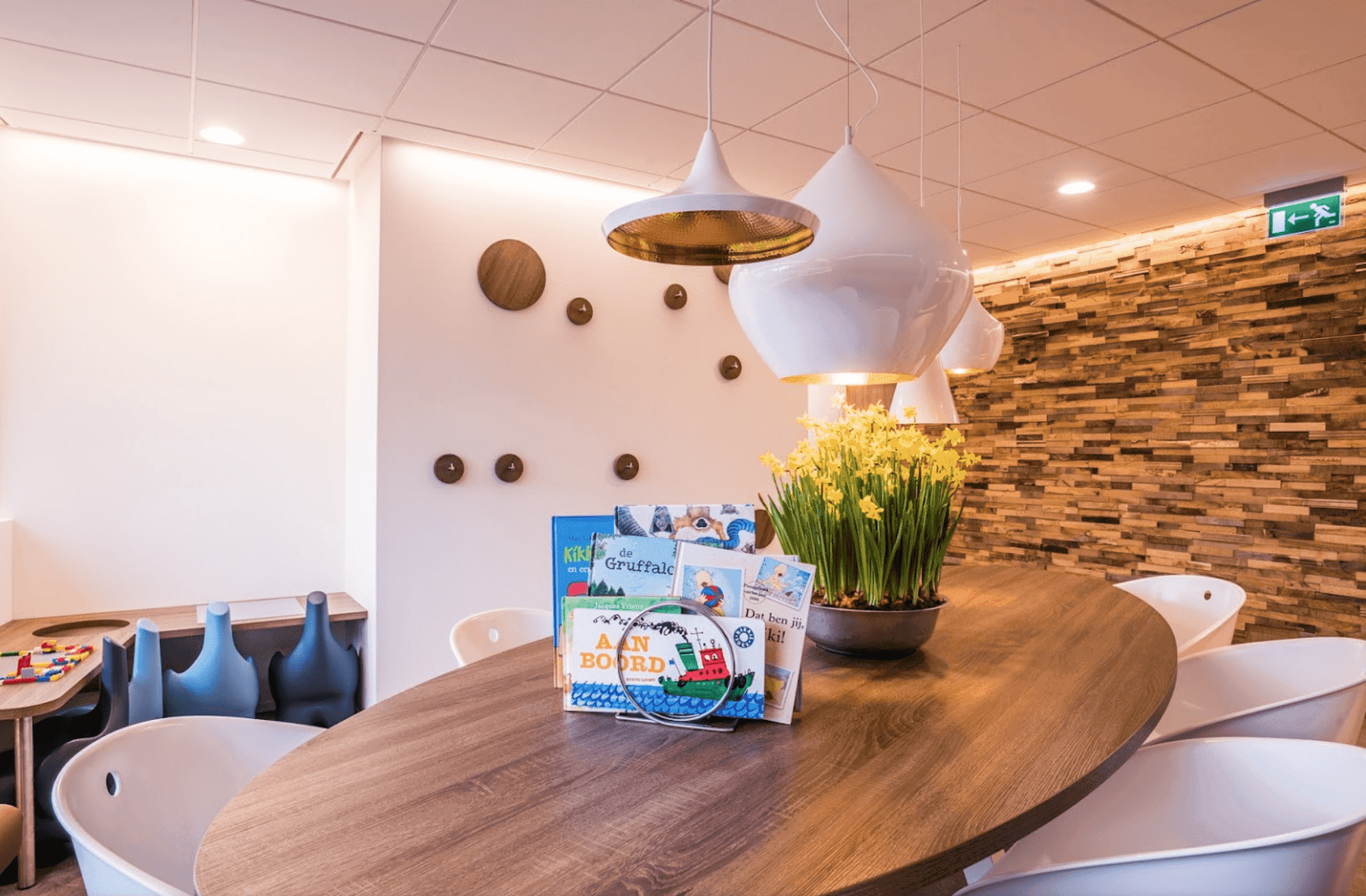 Modern kitchen interior featuring a central island, wooden cabinetry, and bright lighting. Spacious and minimalist design.