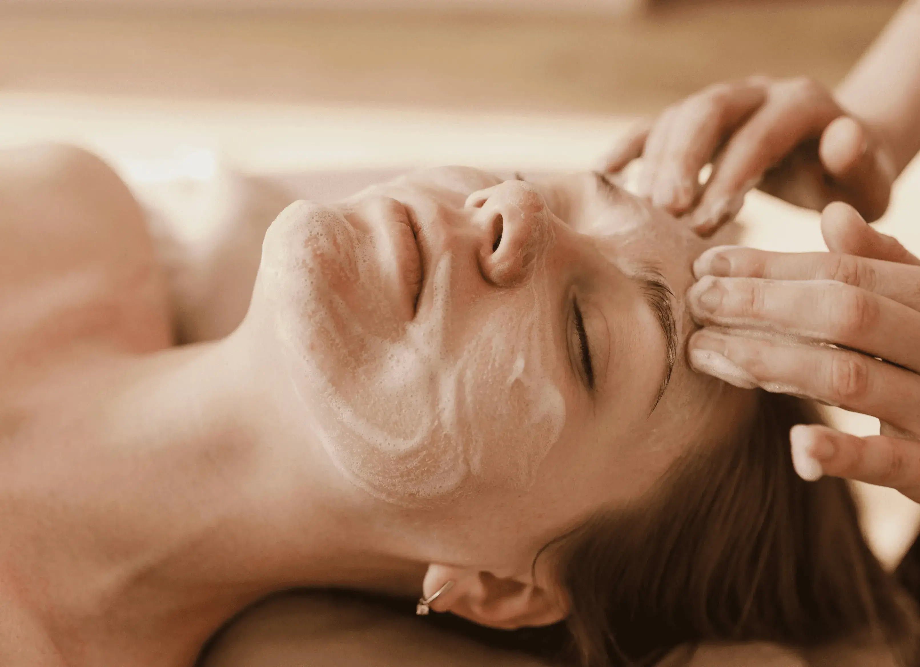 Woman receiving customized facial treatment targeting acne, dark circles, and double chin reduction for clear, balanced skin.