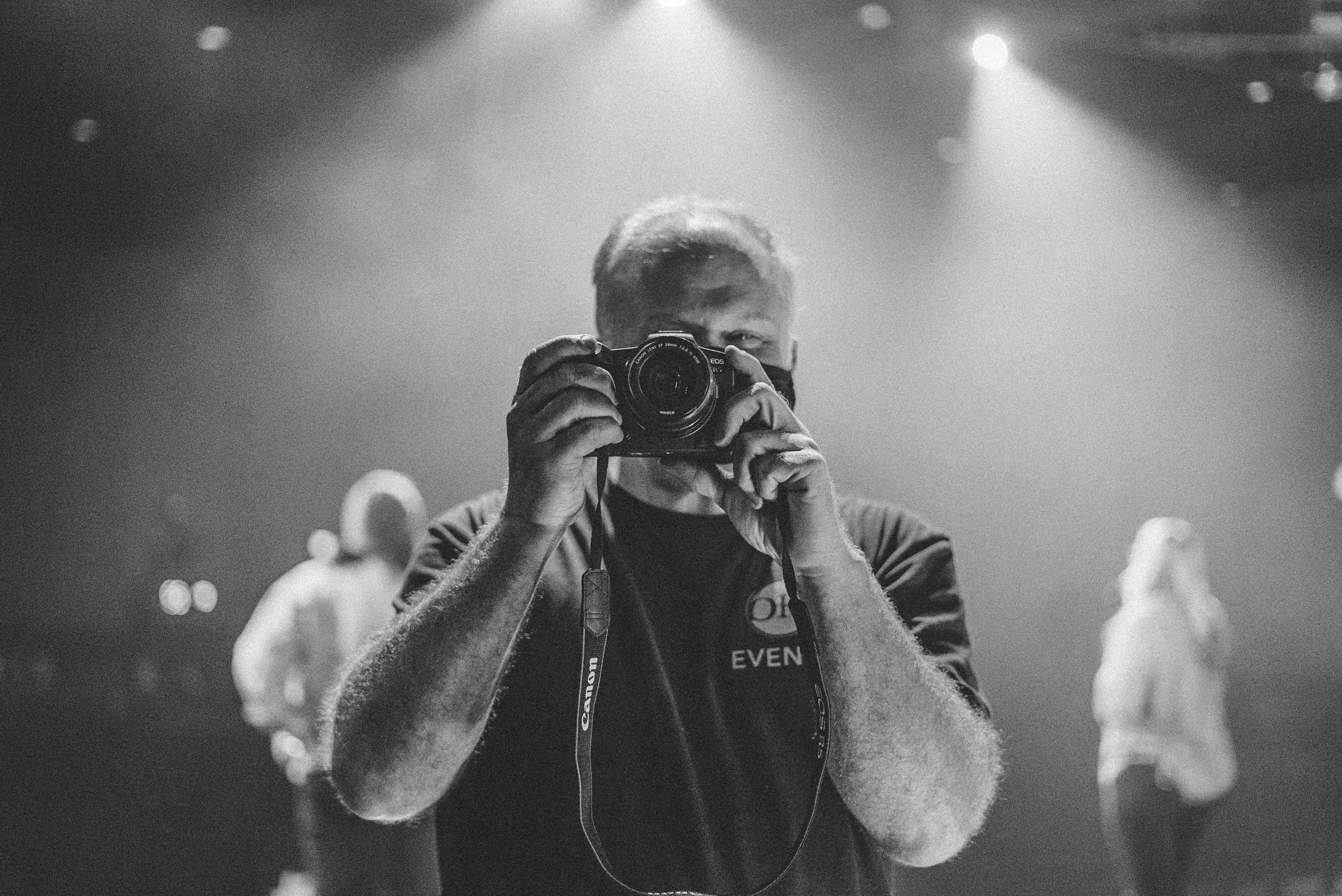 man in black hoodie holding camera