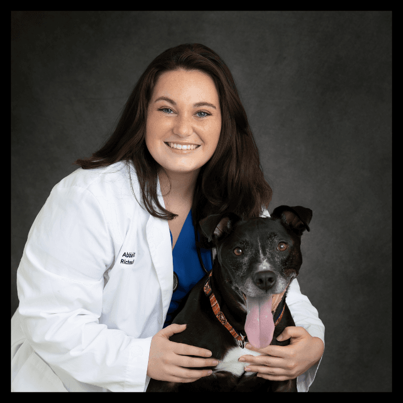 a man with a goatee smiles at the camera
