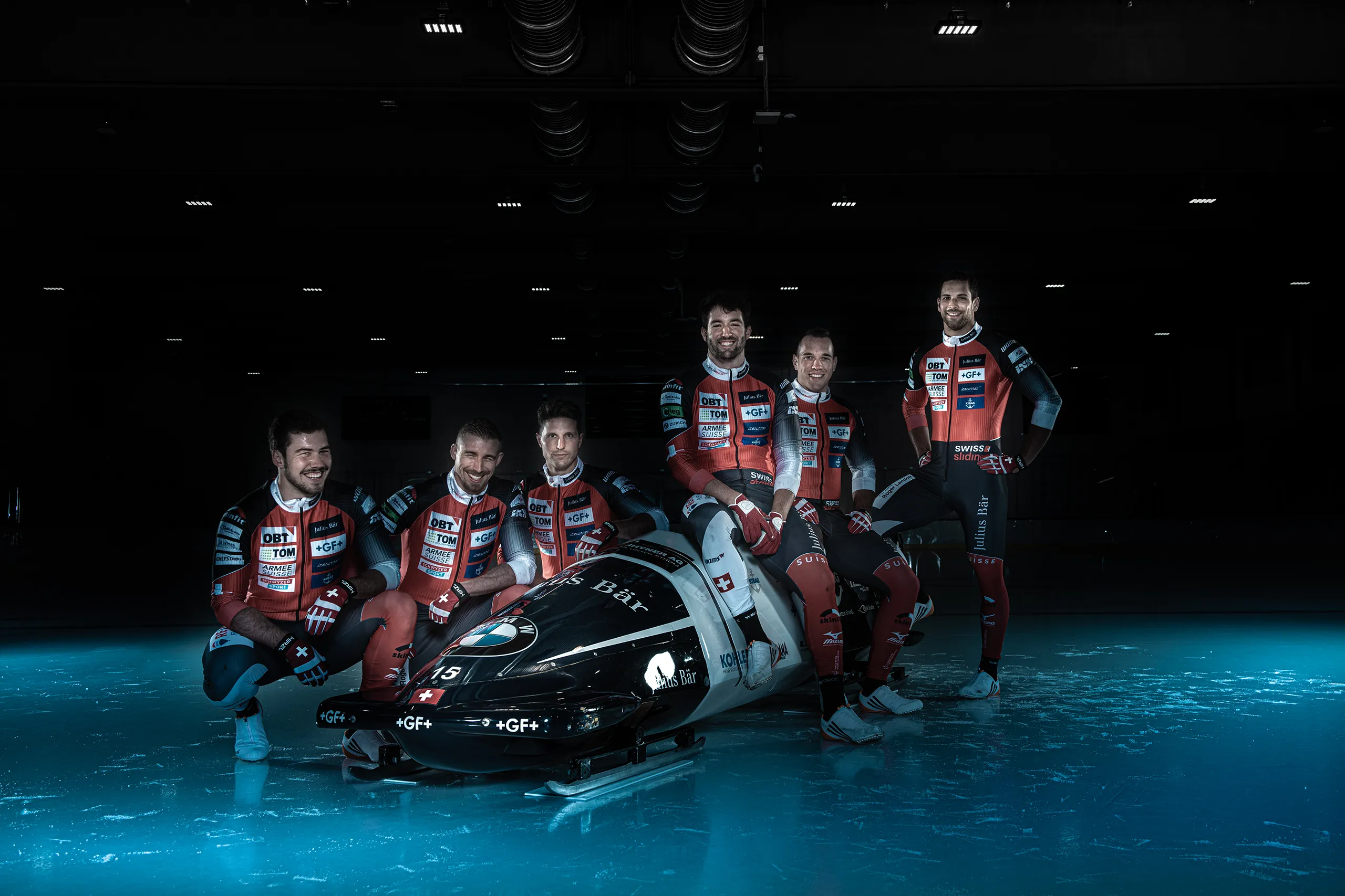 The full Bobteam Vogt crew posing with their bobsled on the ice rink in Zug.