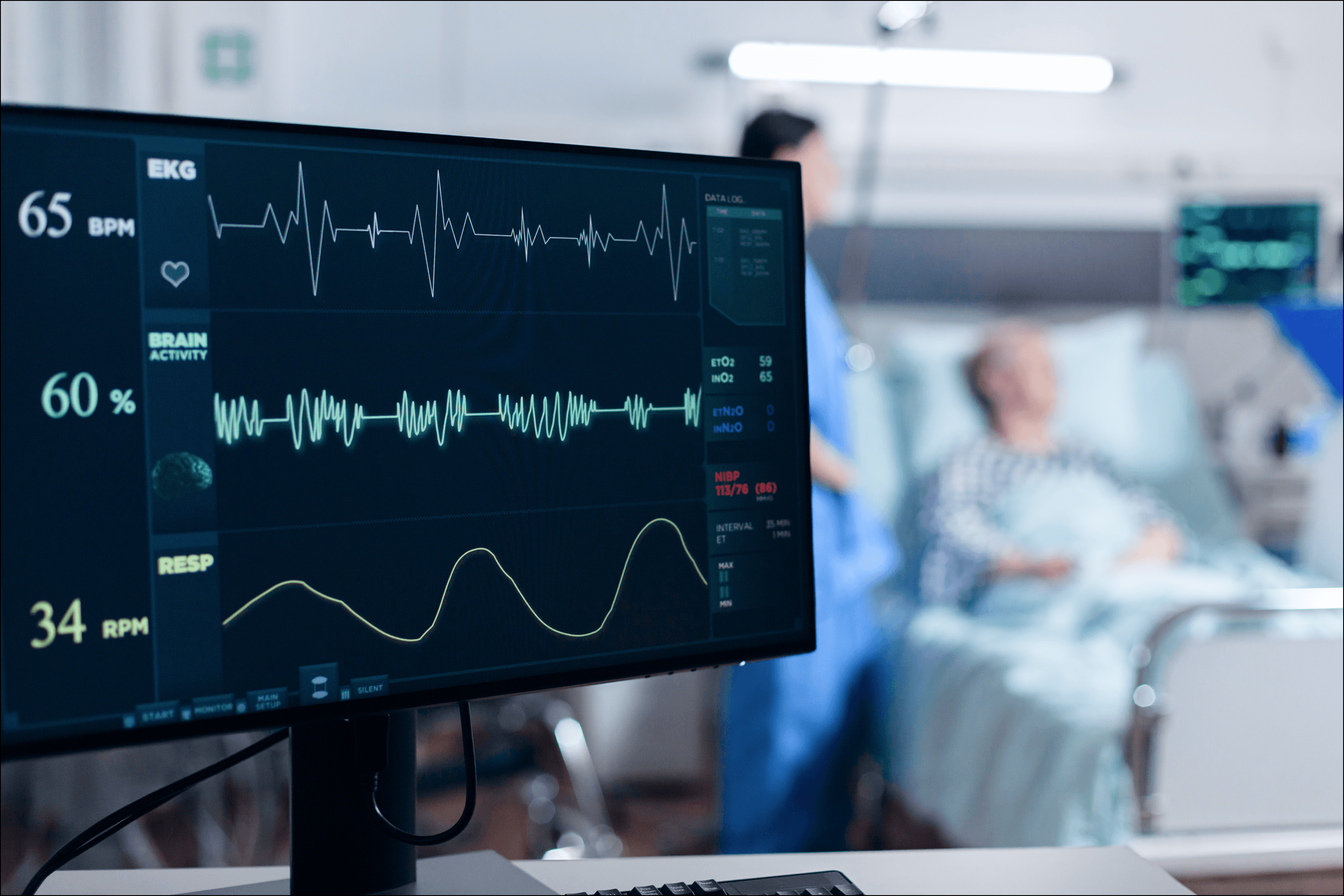Medical monitor displaying real-time EKG and vital signs in a hospital setting, illustrating software as a medical device used for clinical monitoring and regulated healthcare workflows.