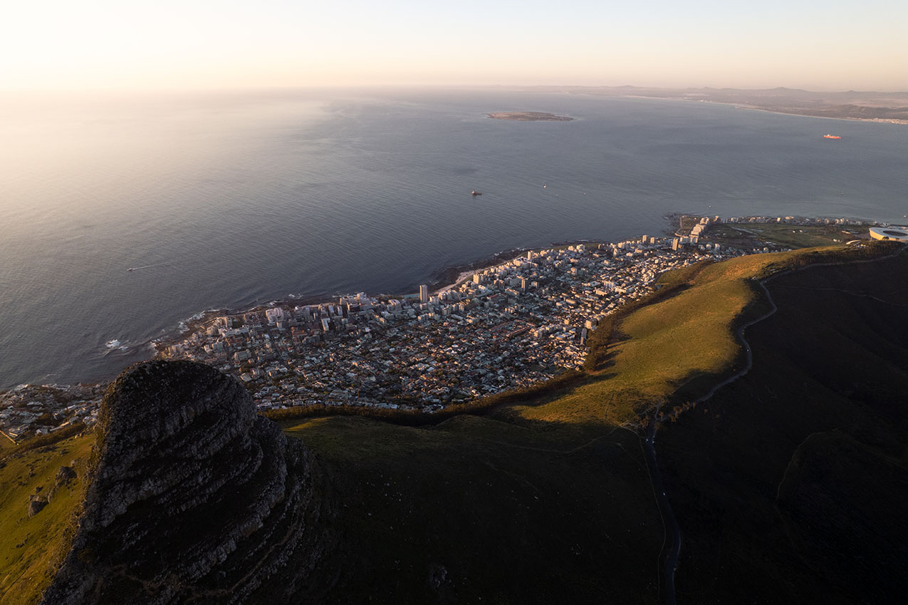 High drone view of Cape Town’s Lion’s Head with city and ocean below, South Africa.