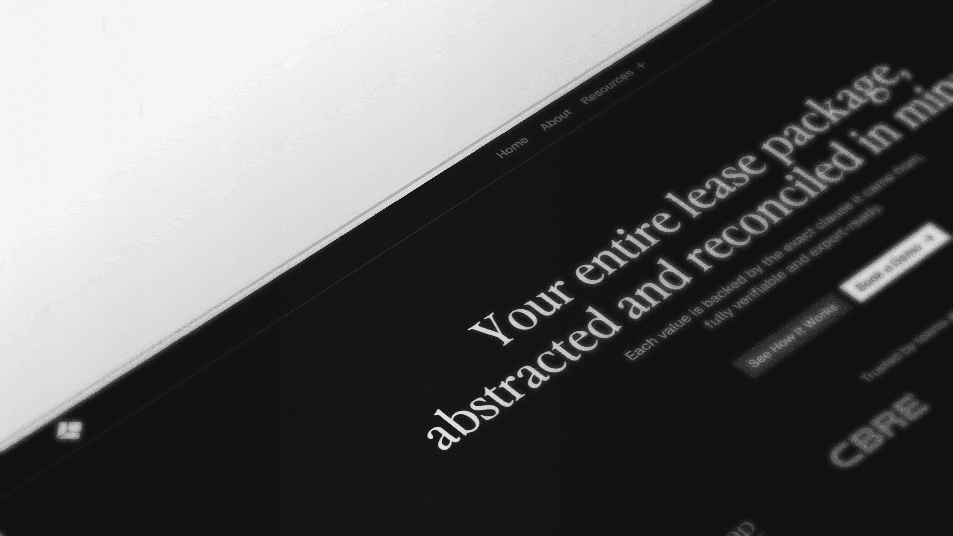 Black and white image of people working at a table with laptops, showing hands gesturing during discussion of digital content displayed on screens, with fabrica® logo in the corner.