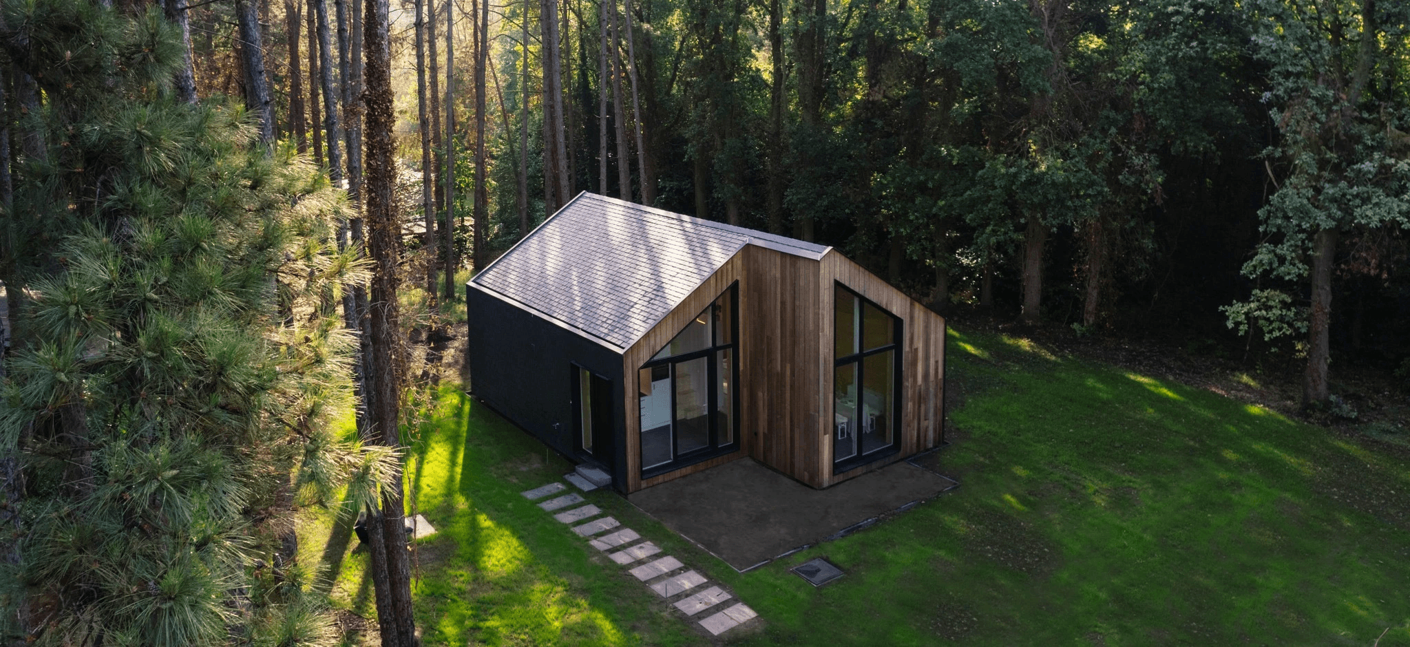 Luxury modern house with wood paneling and large windows.