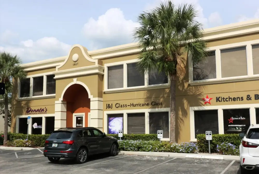 Exterior of J&J Glass headquarters in Naples, FL, showcasing the company’s expertise in custom and impact-resistant glass solutions.
