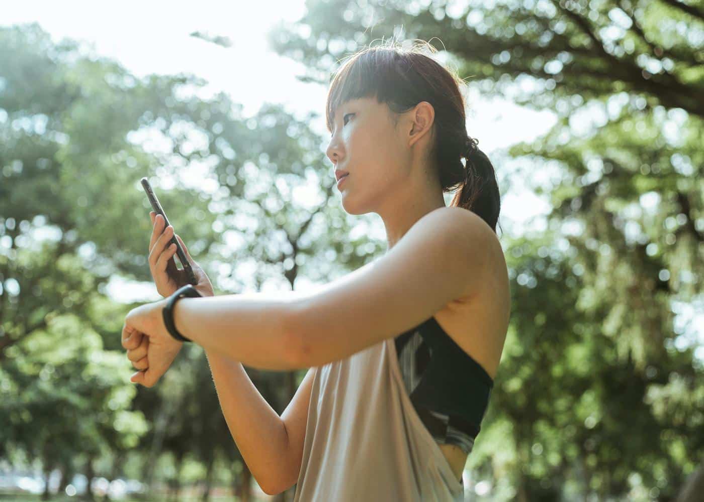 Woman checking her fitness tracker while running