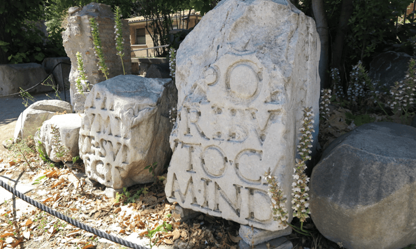 small statues made of rock with engraved text on them