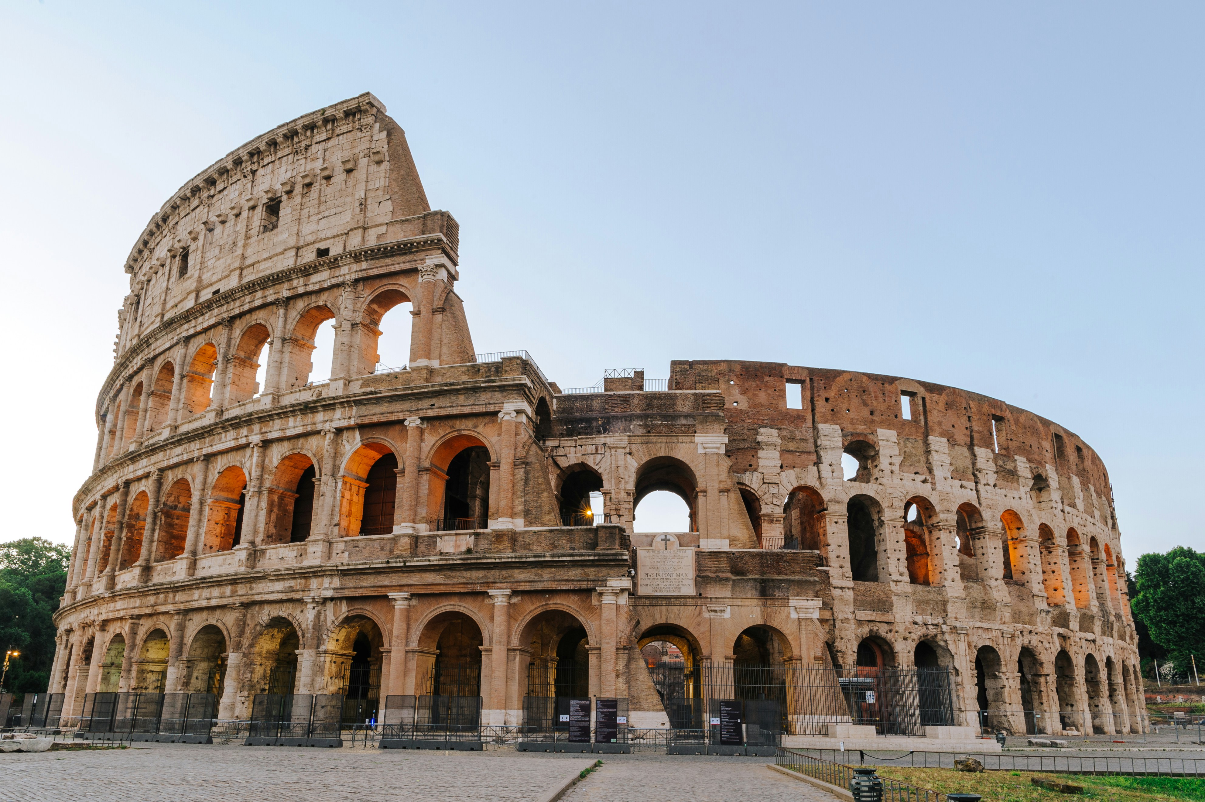 a large stone building with Colosseum in the background