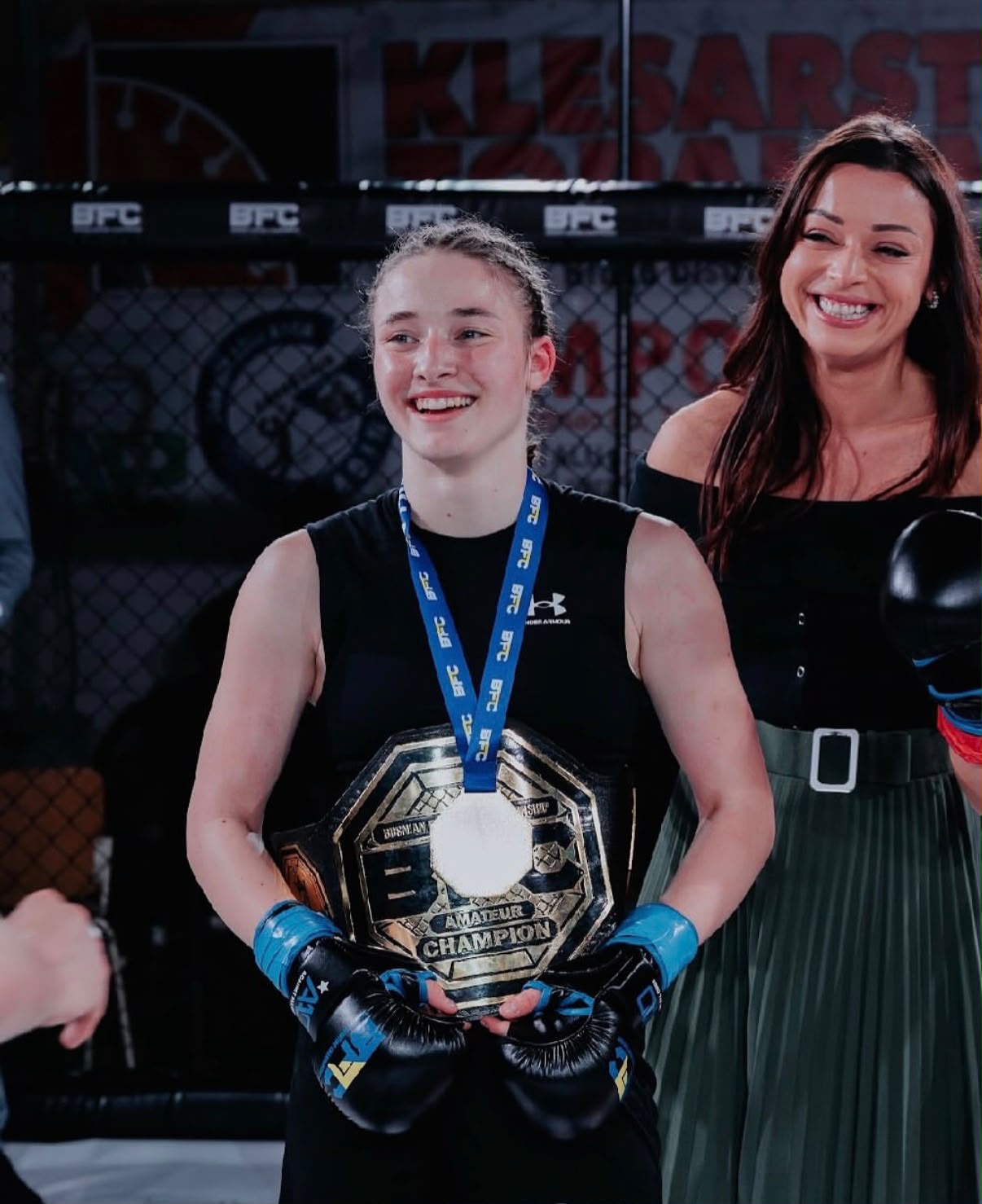 A gym with a boxing ring and fitness equipment