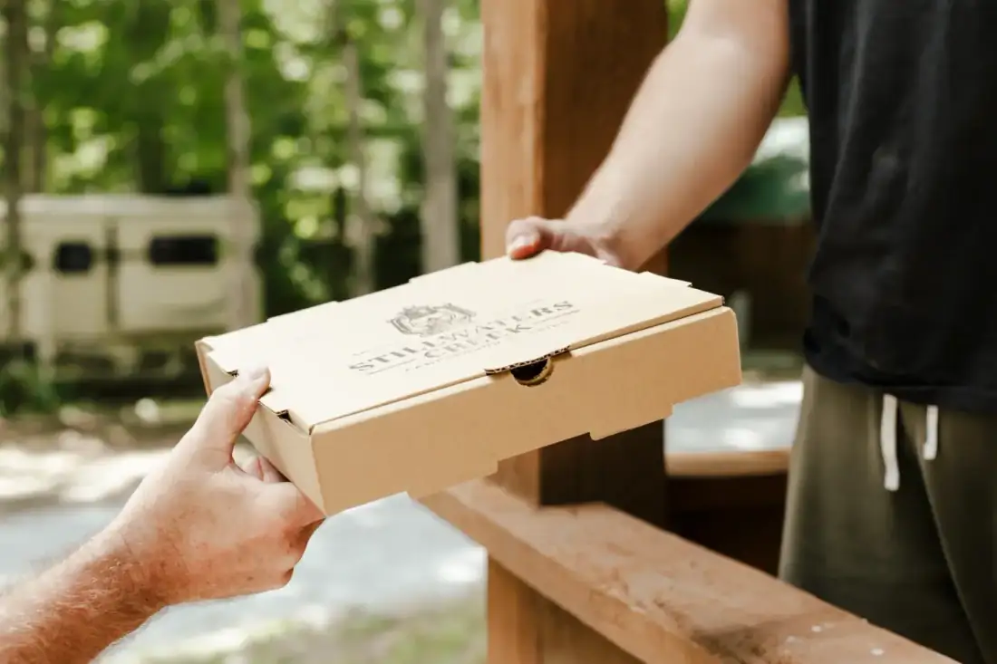 Pizza box being delivered