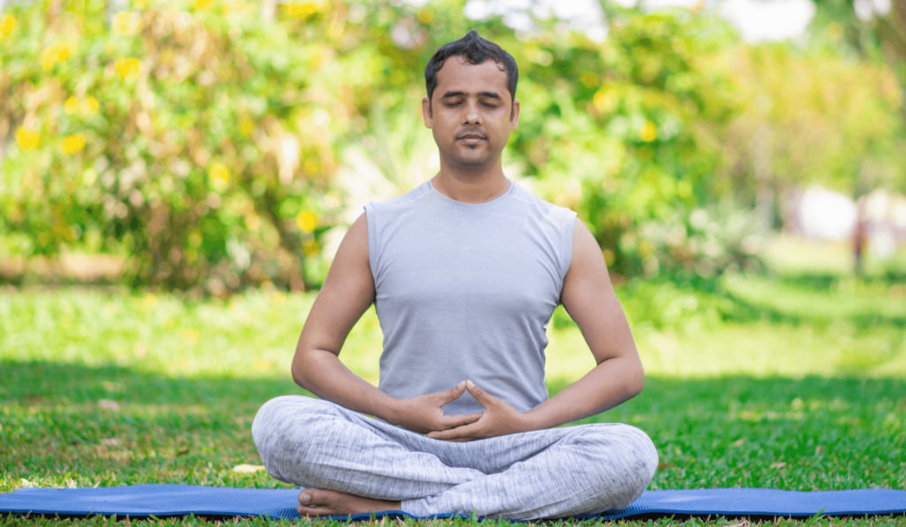 Man practicing yoga and meditation outdoors for relaxation and mental clarity.