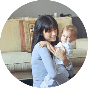 Sally profile picture, holding her baby in home