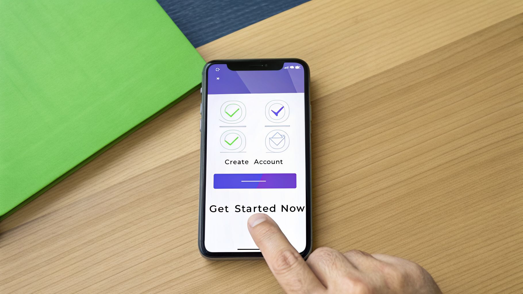 A person's finger taps 'Get Started Now' on a smartphone displaying an account creation screen.