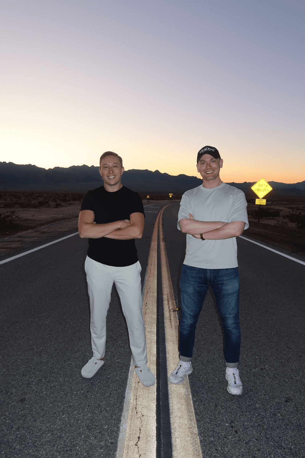 Two men stand on the roadside, reflecting on their journey to create VitaDog Nutrition for better canine wellness.