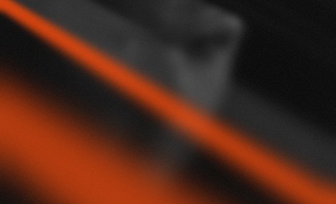 Abstract dark background with a diagonal orange stripe and blurred figure