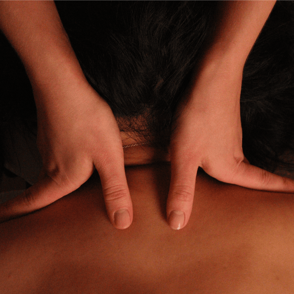 two hands massaging a patient's neck
