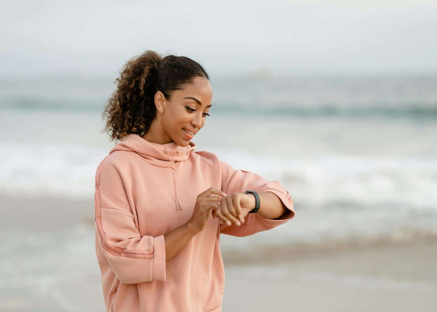 Woman outdoors looking at her smartwatch