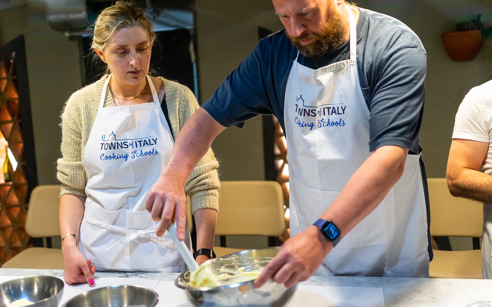 Cooking class participants preparing pasta in Milan.