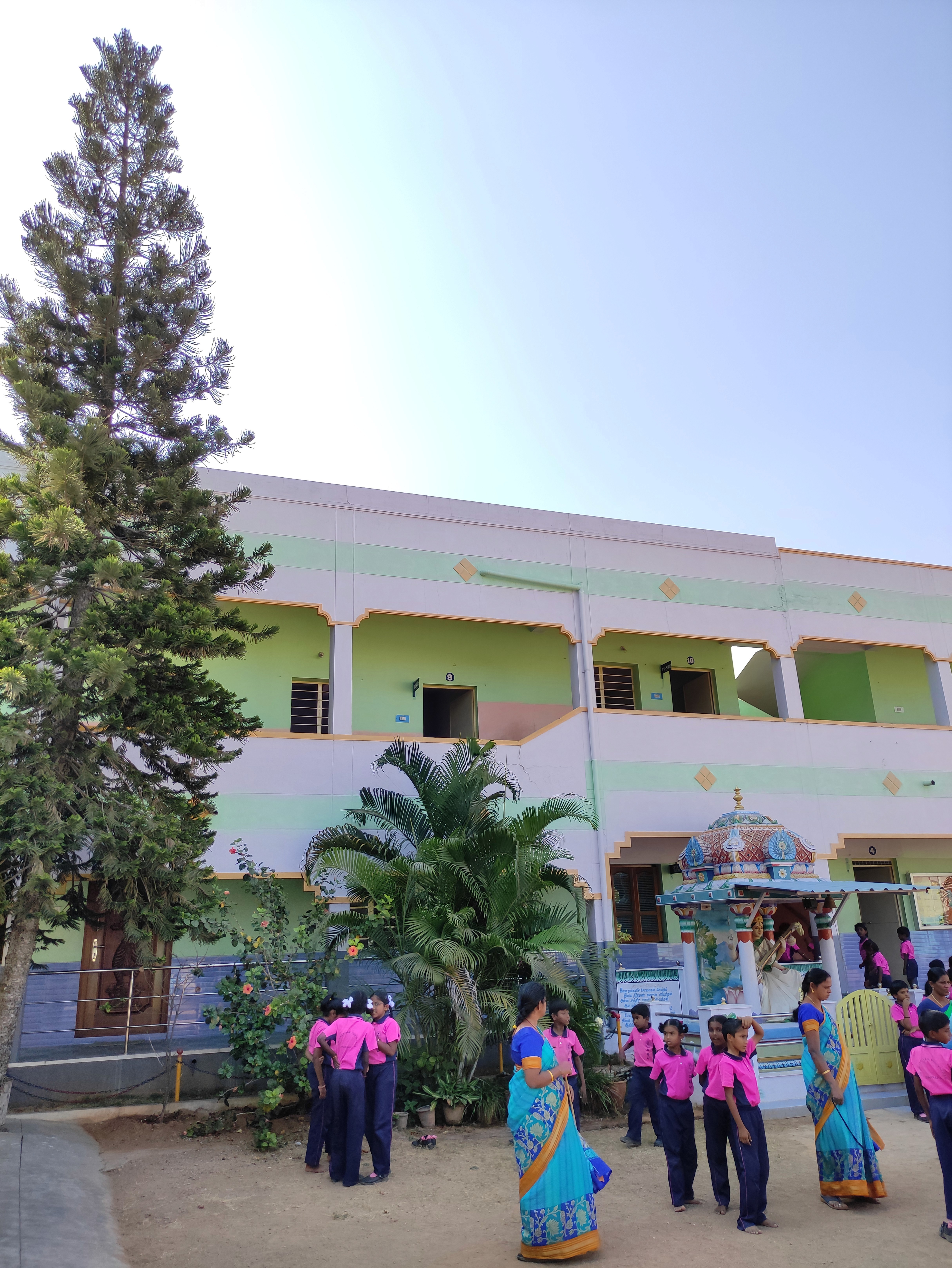 A school building stands against the backdrop of a clear sky