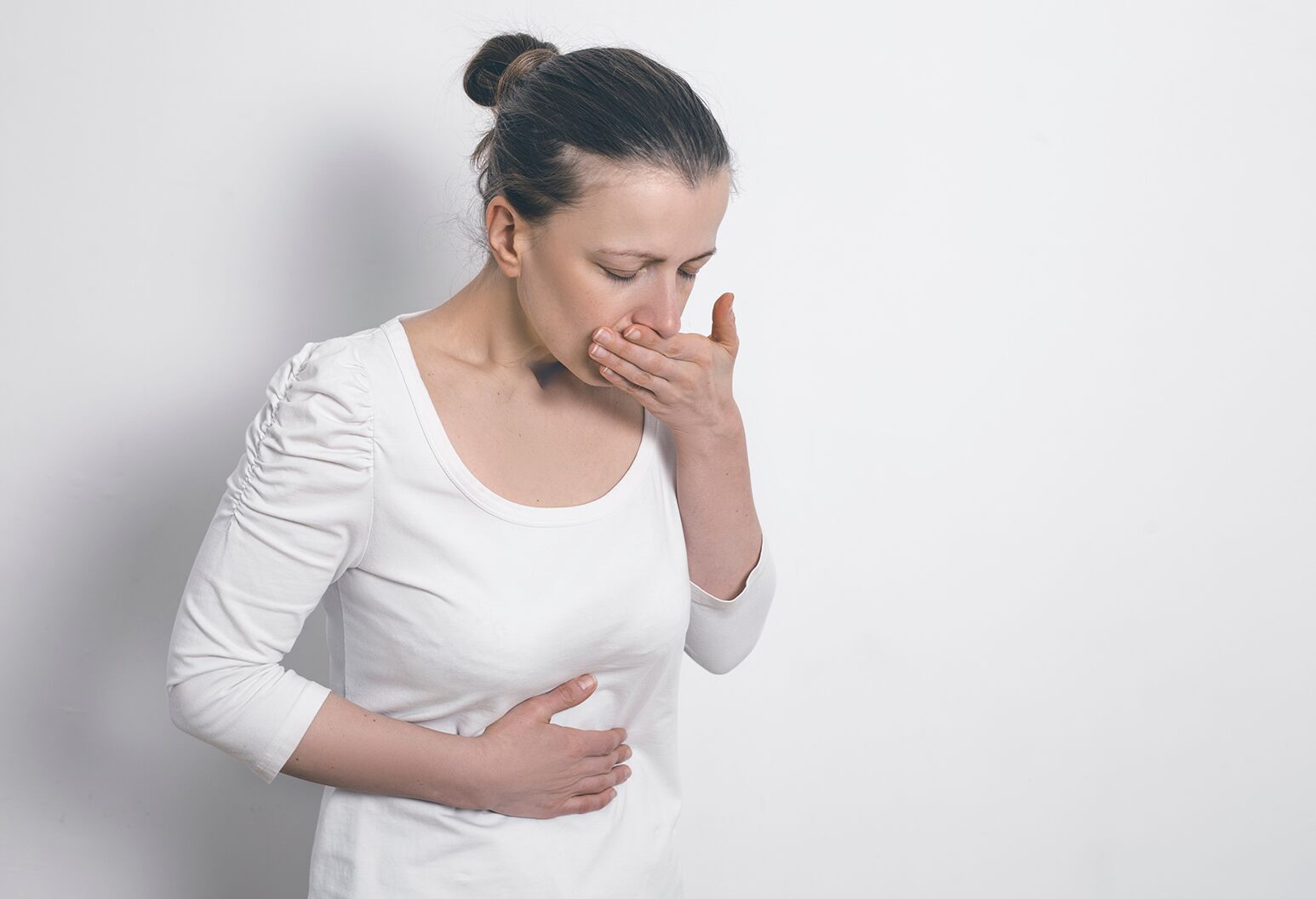 woman about to vomit - Tirzepatide vs Semaglutide Side Effects  