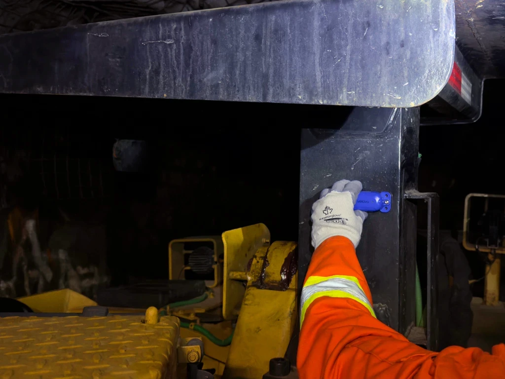 Velavu Pavo HD tag attached to a scoop vehicle underground