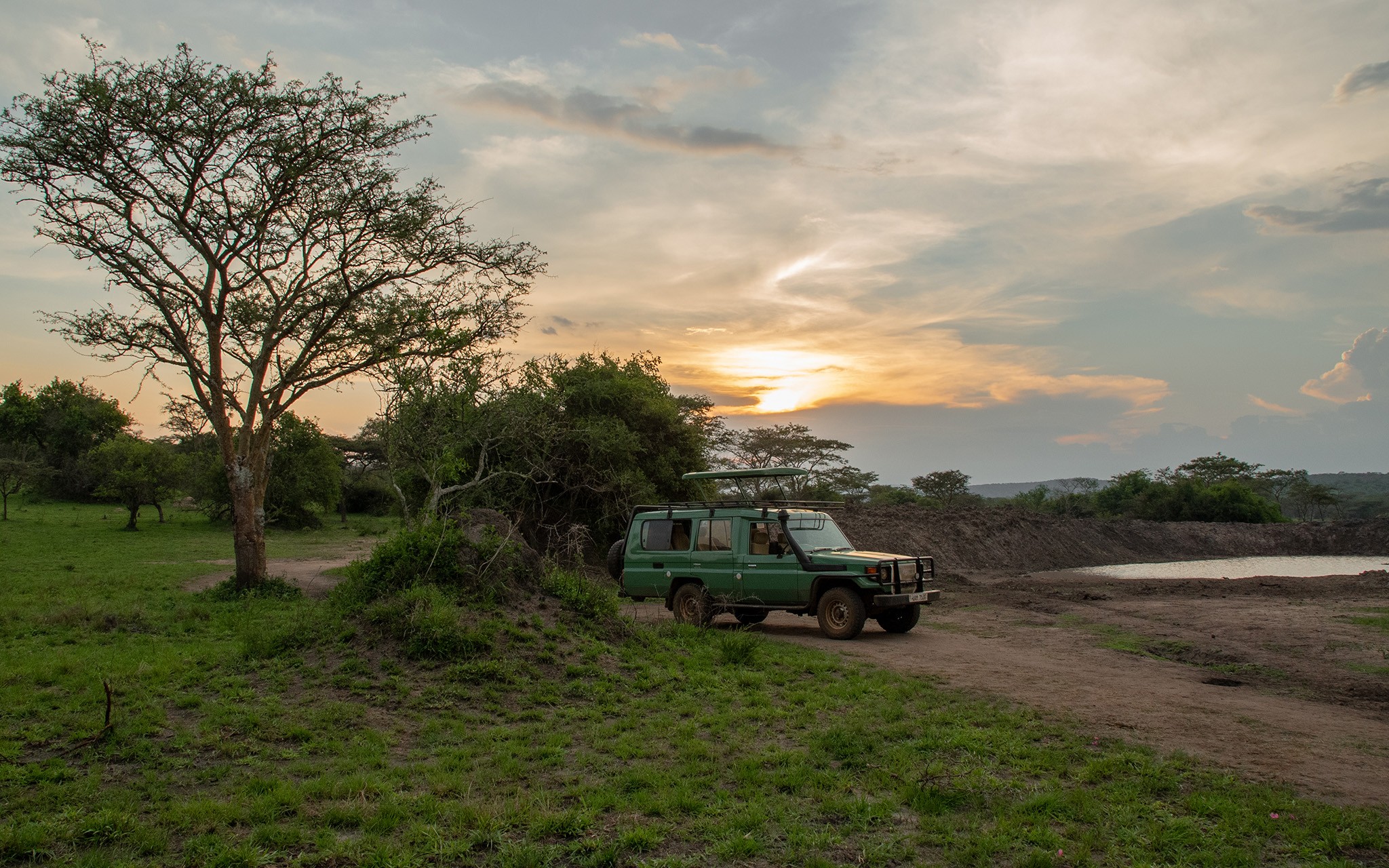 Tourists in a safari car in Lake Mburo - Admiring the concept of waterholes in the wild