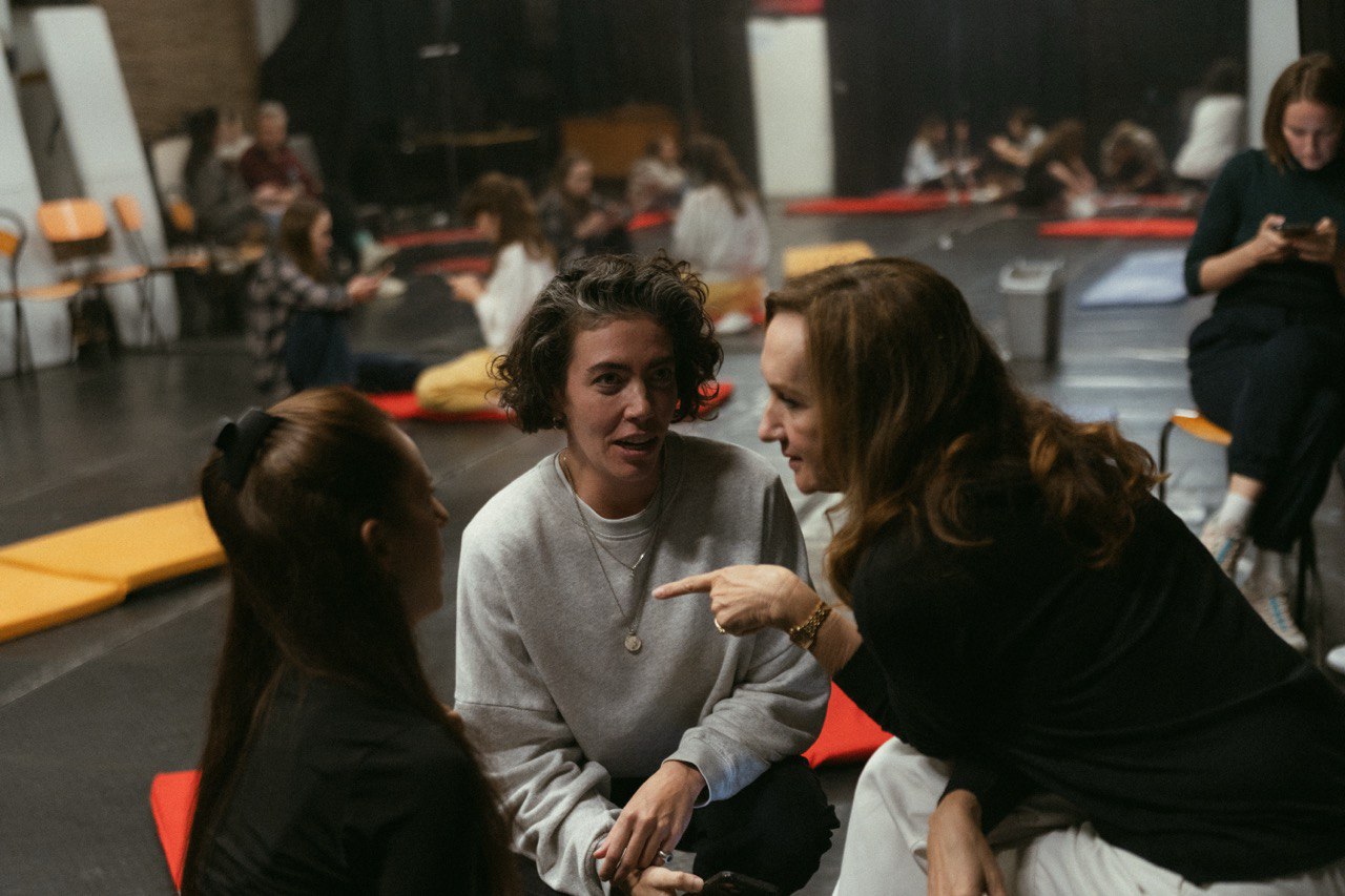 man wearing gray polo shirt beside dry-erase board