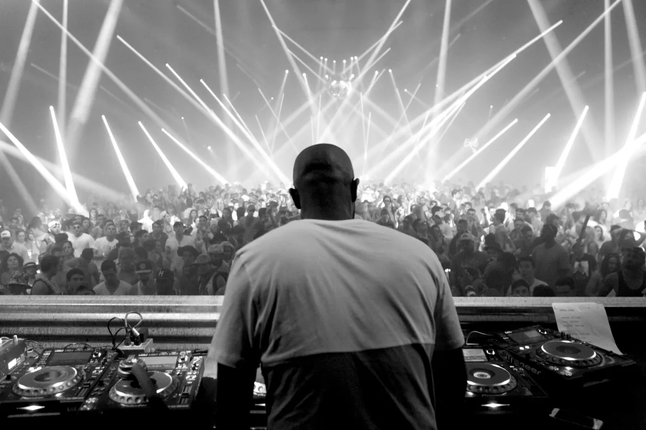 Jay Stylez performing for a packed dance floor with stage lighting
