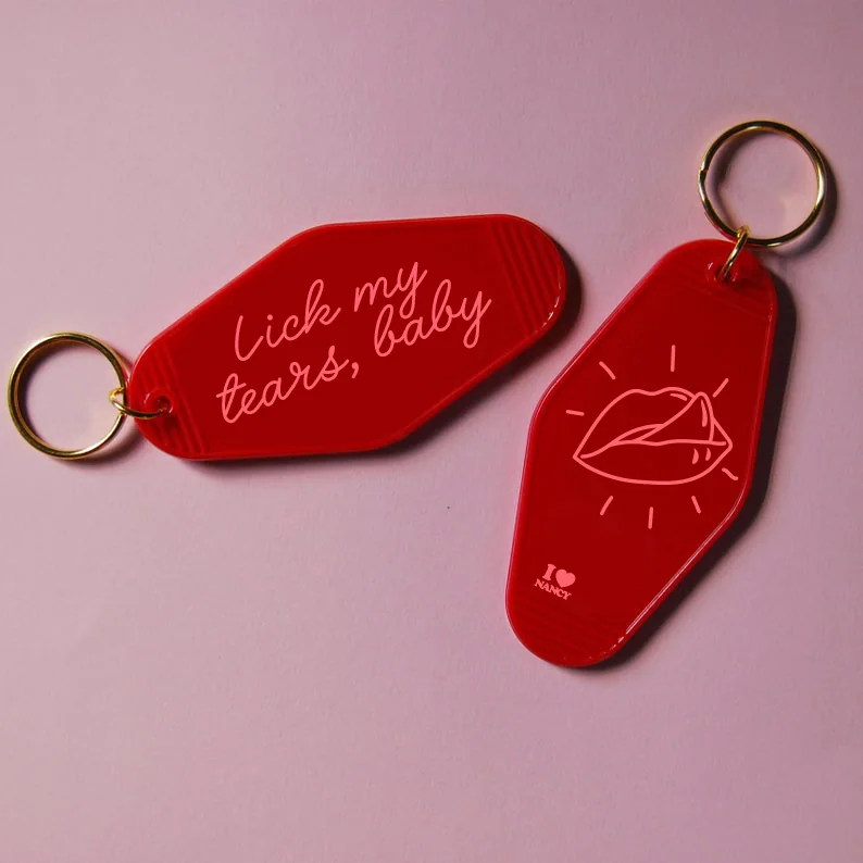 Red key tags with Lick My Tears Baby lettering.