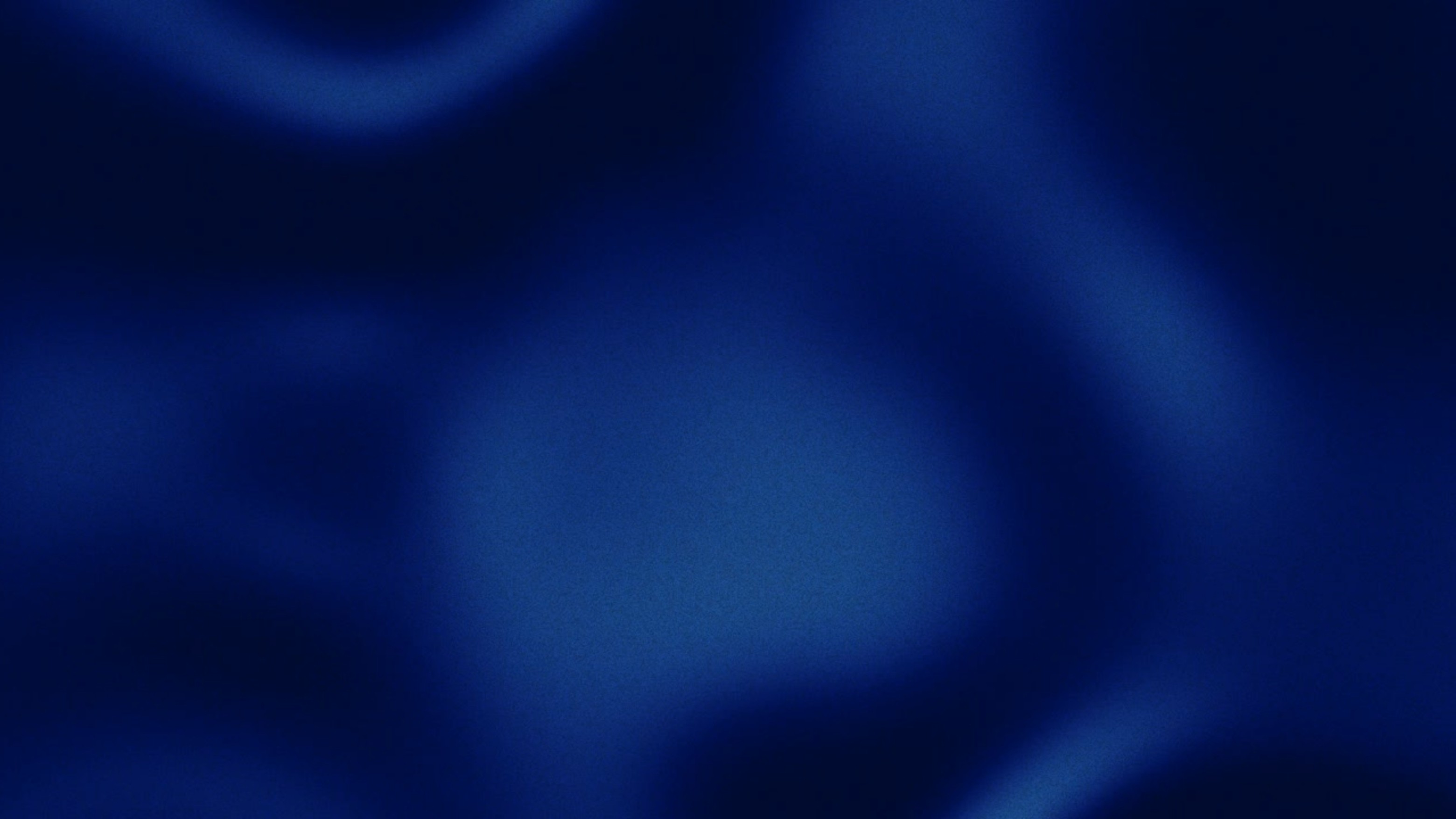 A gradient image transitioning from dark black to light gray tones.