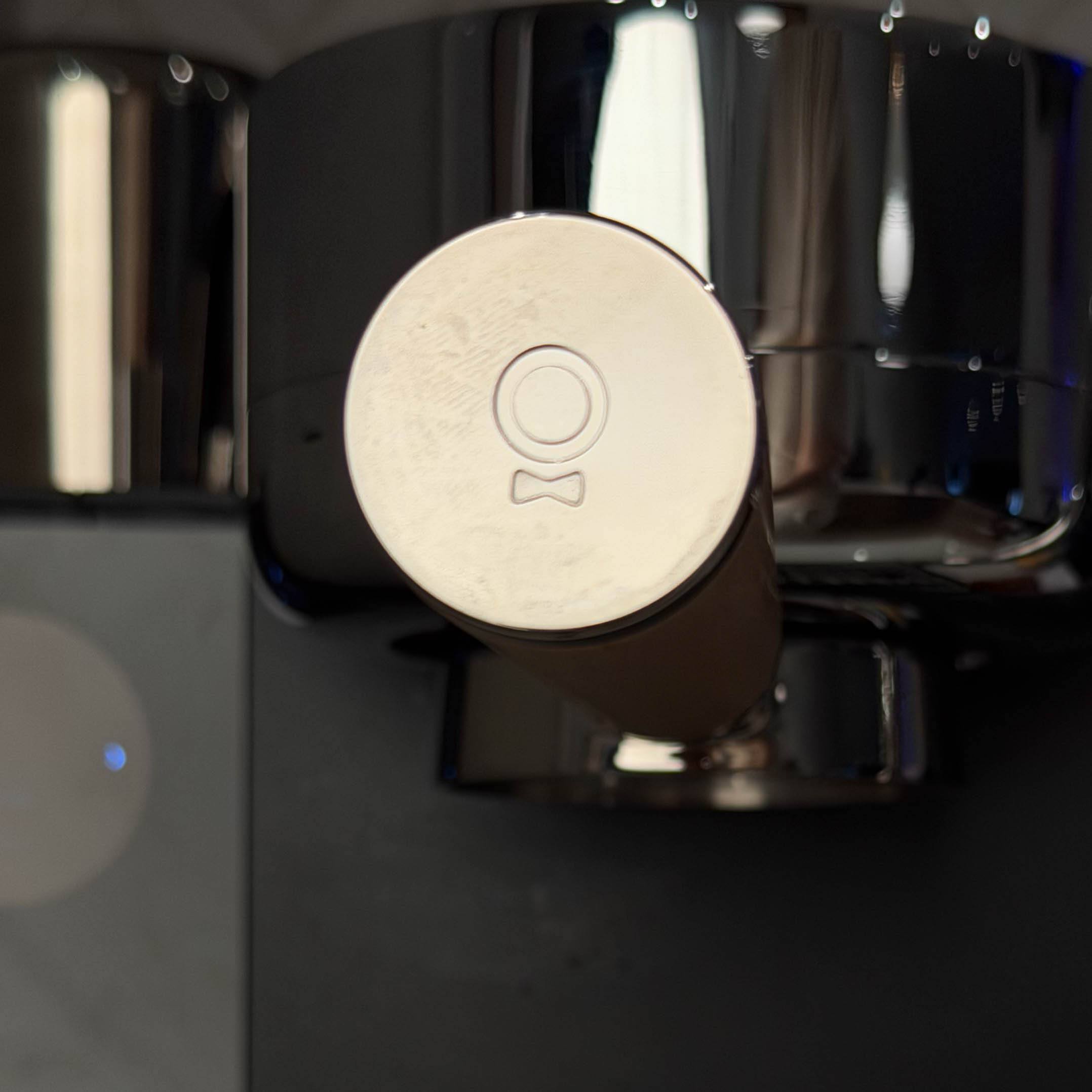 a portafilter handle with the fellow logo on the end in embossed chrome