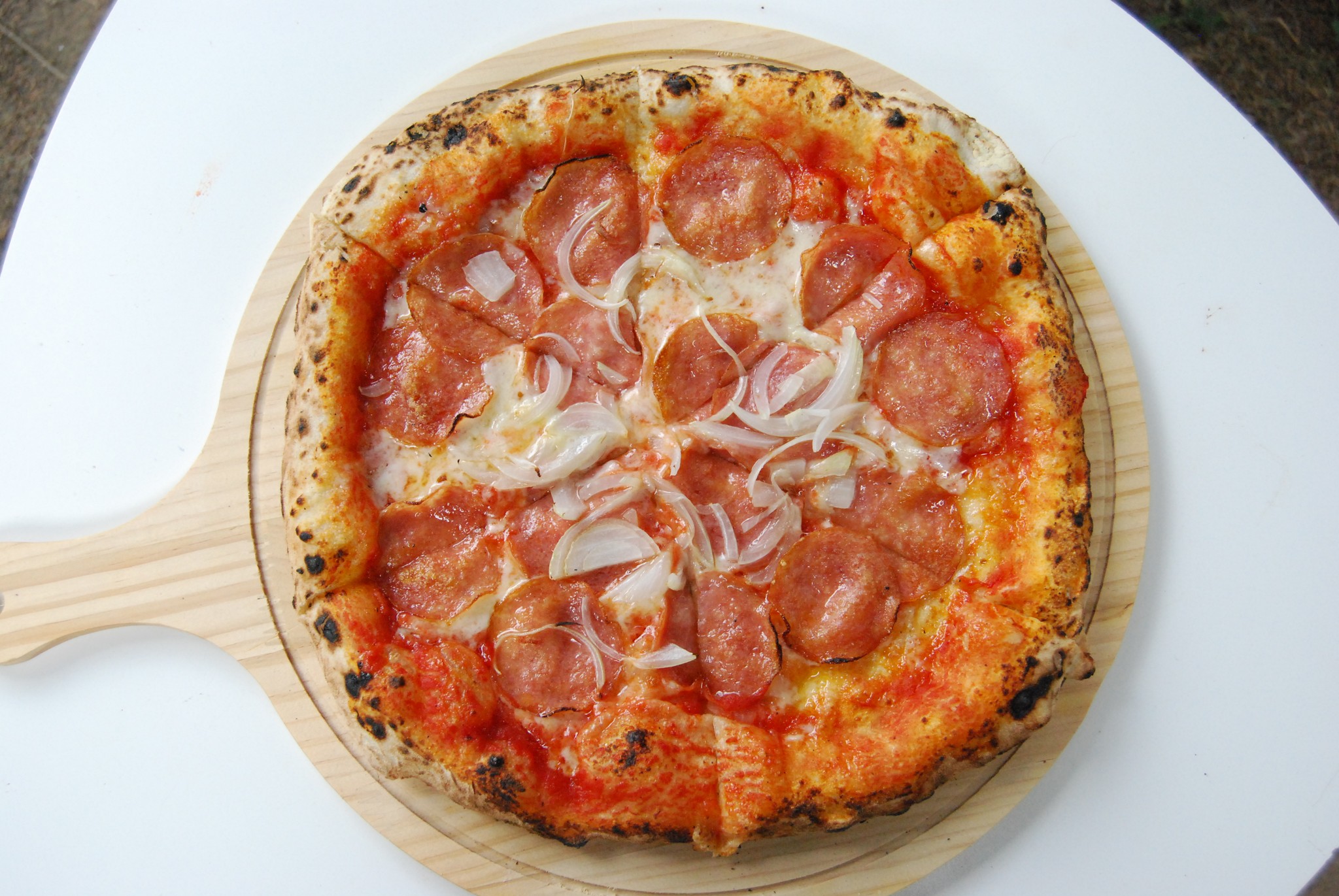 Peperoni Pizza on a wooden plate